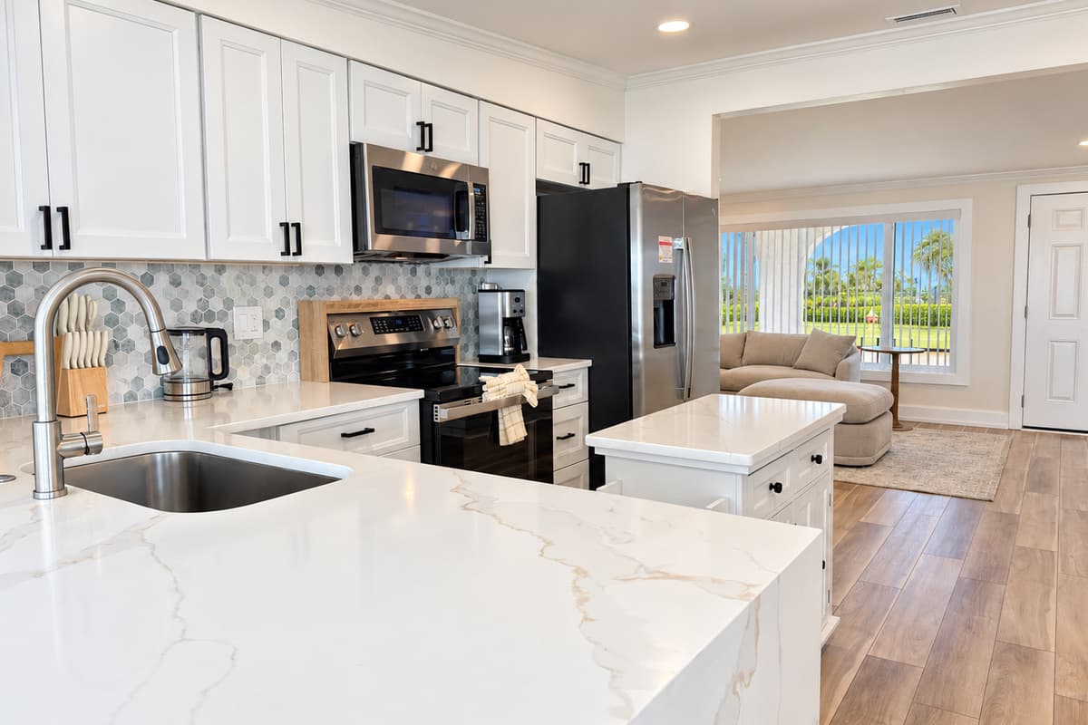 Kitchen with an island, stainless appliances and space to prepare meals.