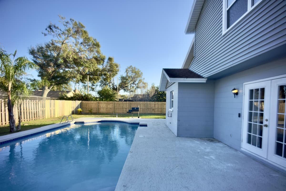 Whether you're swimming, lounging, or simply enjoying the peaceful atmosphere, this backyard offers a stunning escape right at home.
