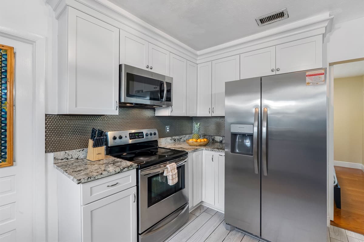 Enjoy meal prep in this clean, updated kitchen with high-end appliances and plenty of storage.