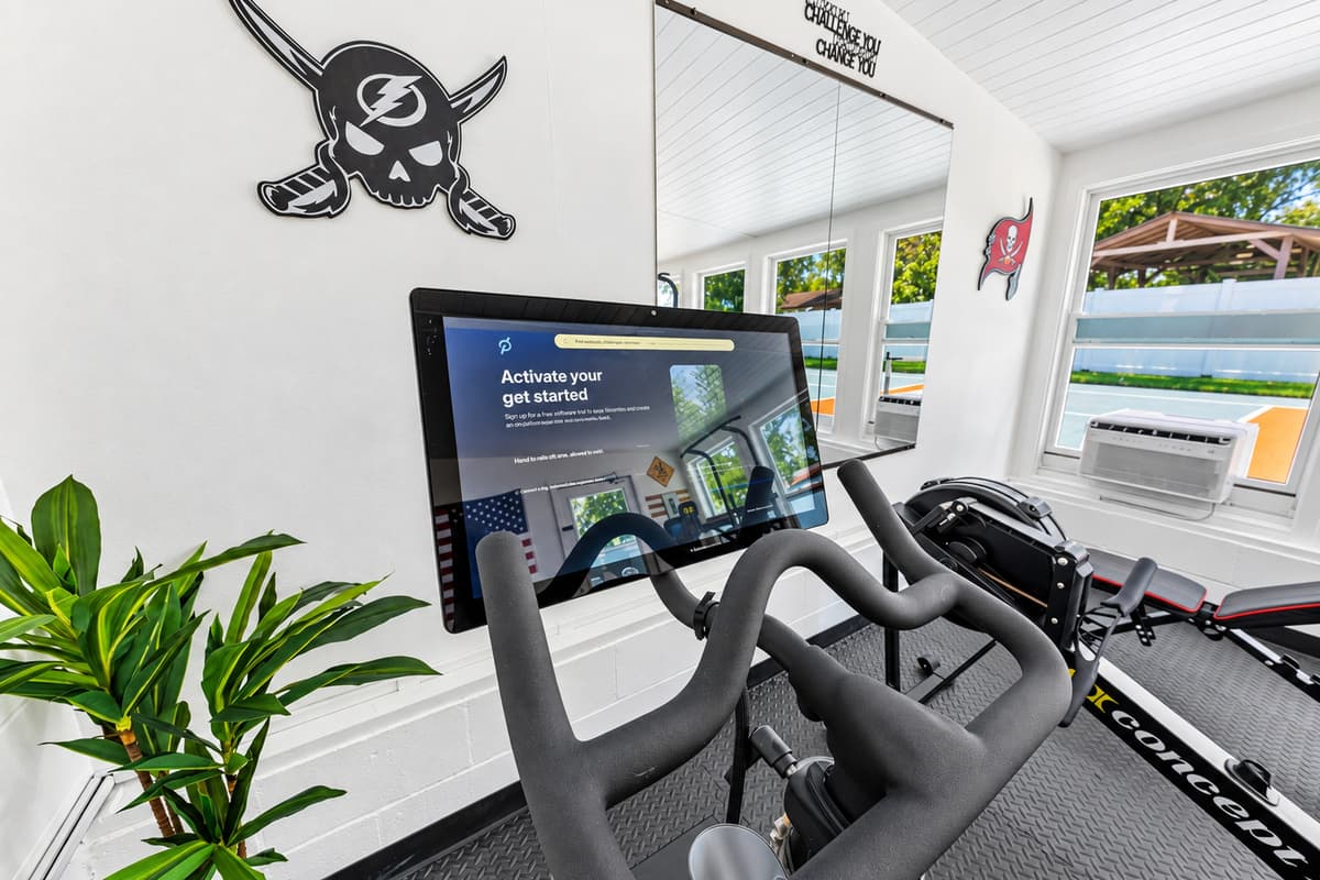 Get your heart pumping with the stationary bike while enjoying bright natural light and backyard views.