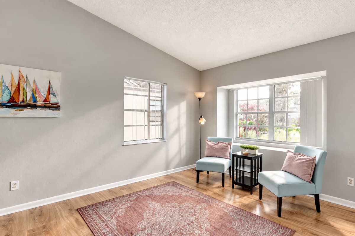 An inviting extra seating nook bathed in natural light by the window.