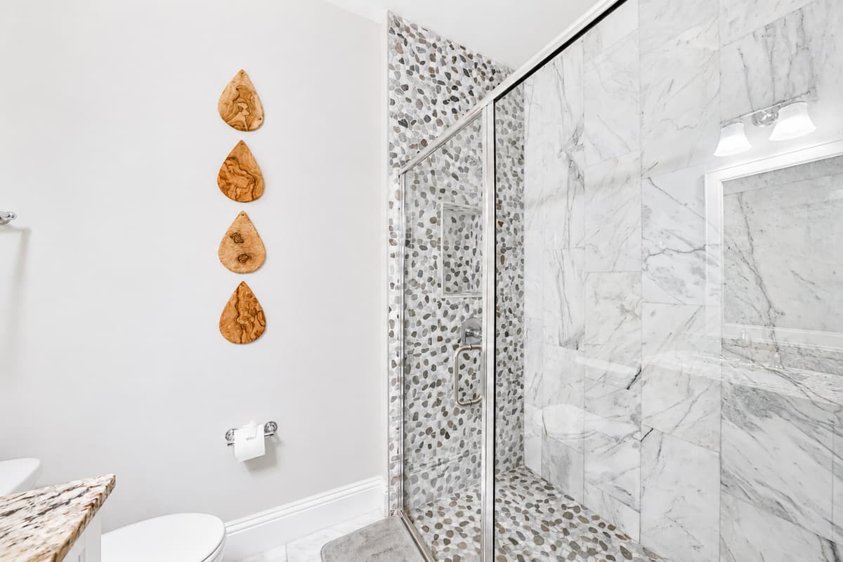 Refresh in the beautifully tiled walk-in shower, designed with modern finishes for a spa-like experience.