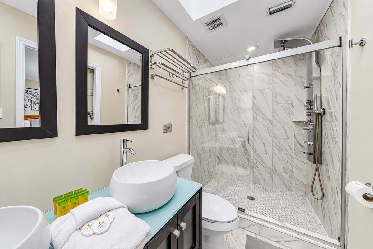 Spa-inspired bathroom featuring an oversized glass-enclosed walk-in shower.