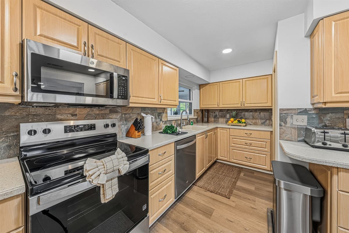 Modern kitchen with stainless steel appliances and functional layout for easy cooking and dining 