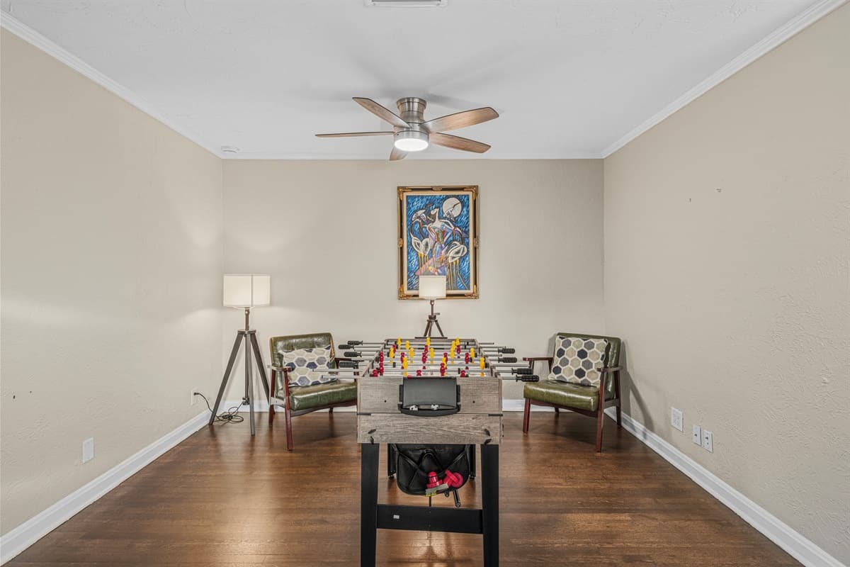 Stylish game room setup with foosball table and lounge chairs for relaxing between games.