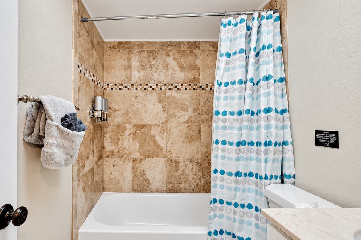 Immerse yourself in the serenity of a rejuvenating shower in our modern walk-in shower, surrounded by beautiful white clean-finish interiors.
