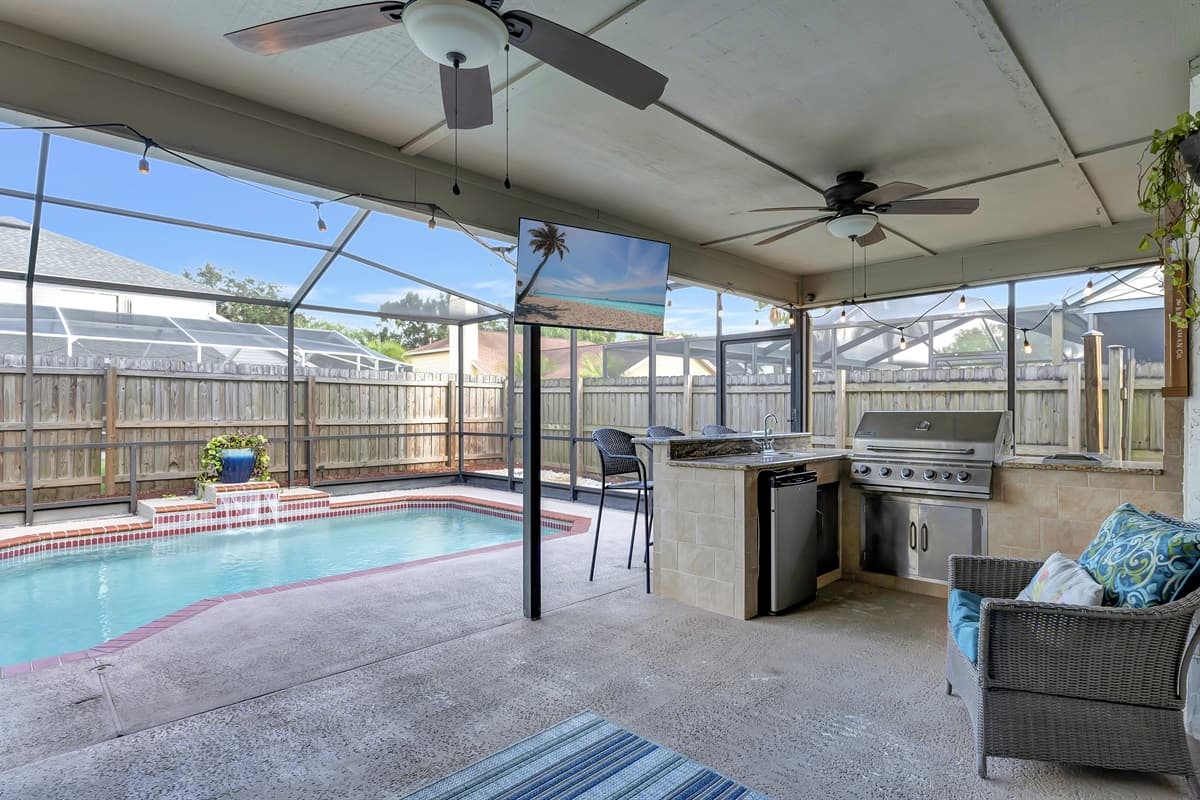 Featuring cozy seating arrangements and a compact outdoor kitchen complete with a grill.