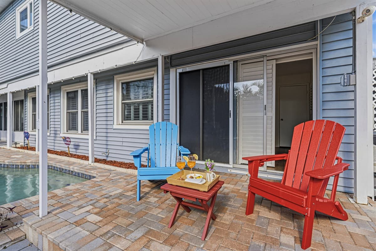 Poolside seating area just steps from the water—ideal for lounging and enjoying the outdoors 