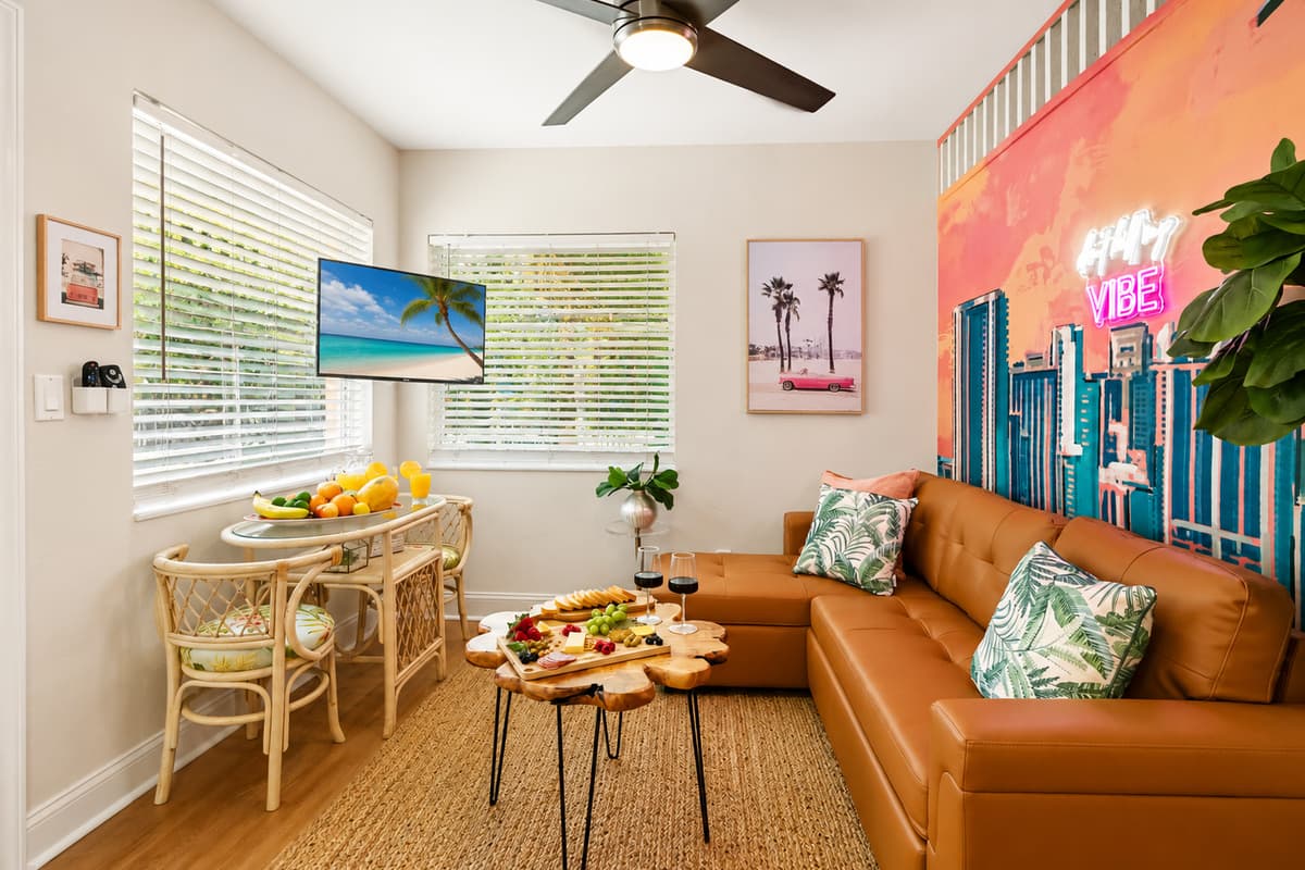 Relax in the vibrant living area with comfortable seating, Smart TV, natural light, and a dining nook perfect for meals or morning coffee.
