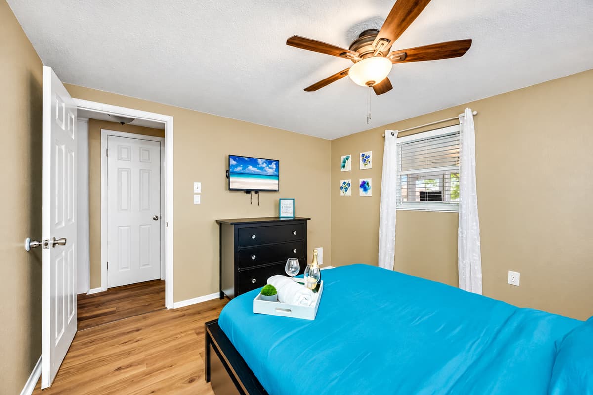 This spacious bedroom has a queen sized bed, smart TV, and drawers for storage. This bedroom will surely make your stay in this property the best among others.