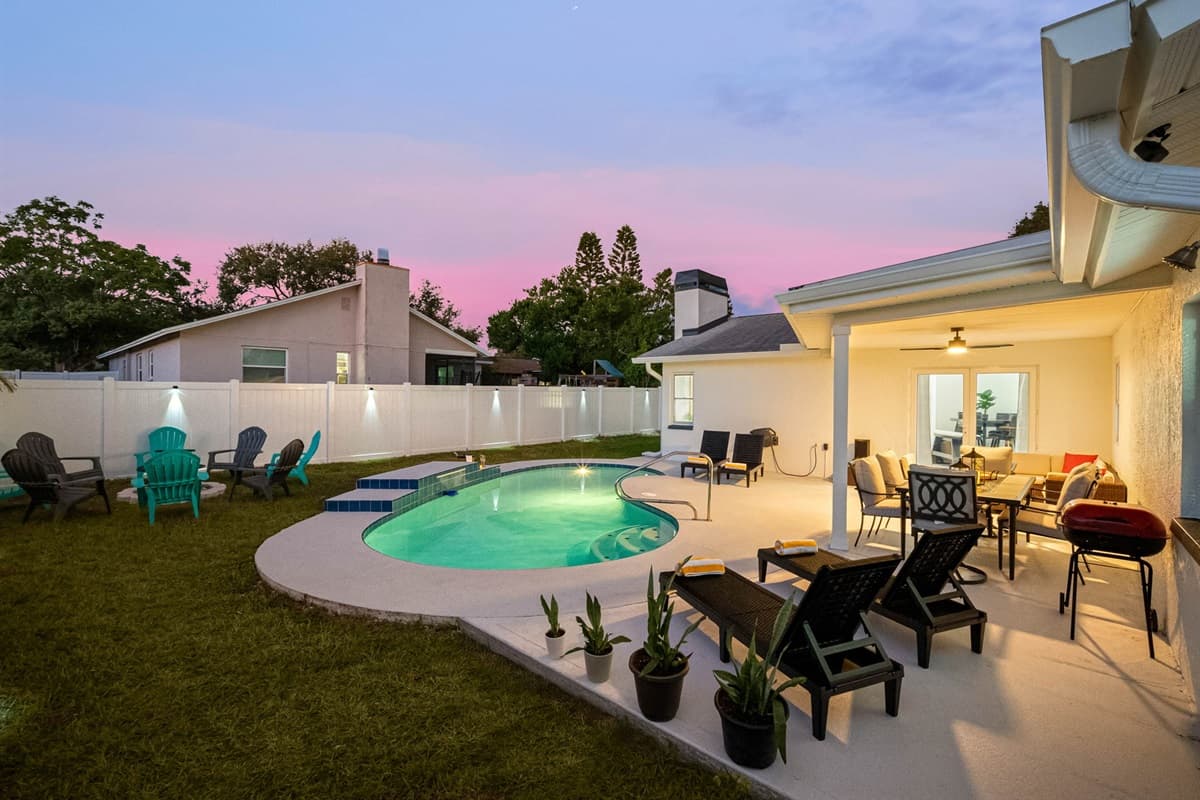 Enjoy golden-hour views from your private pool surrounded by soft lighting and cozy seating. Whether for a relaxing swim or dinner outdoors, this space sets the mood beautifully.