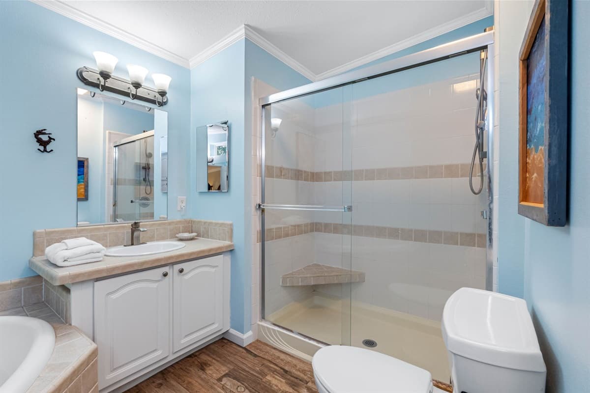 A glass-enclosed shower-tub combo offers convenience and style, perfect for relaxing after a day of adventure.