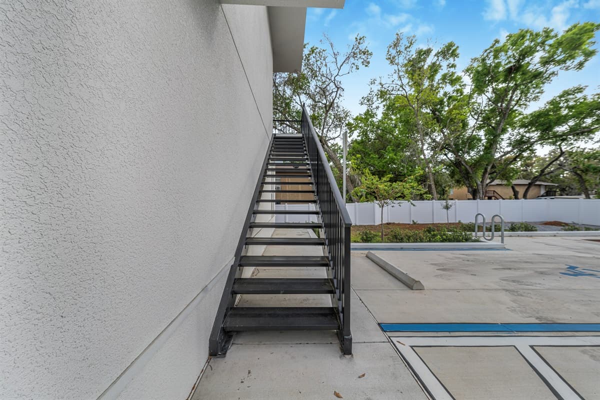 Your 2nd-floor unit catches the Florida breeze and offers elevated views of the neighborhood greenery below.