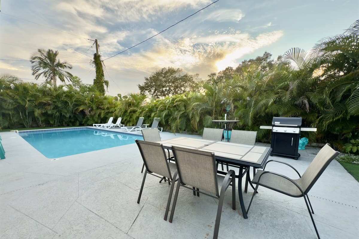 The outdoor patio includes a dining set for six, ideal for meals under the Florida sun or stars.