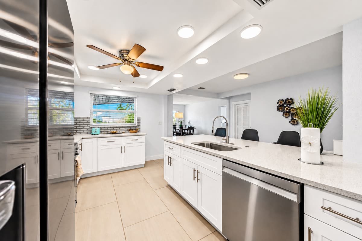 Spacious open-concept kitchen with oversized island, dishwasher, and modern décor.