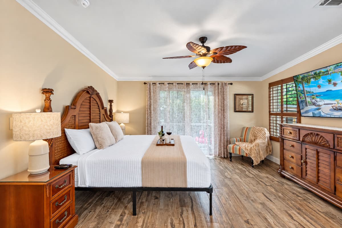 Relax in a beautifully styled master bedroom featuring a luxurious king bed, soft linens, and soothing neutral tones.