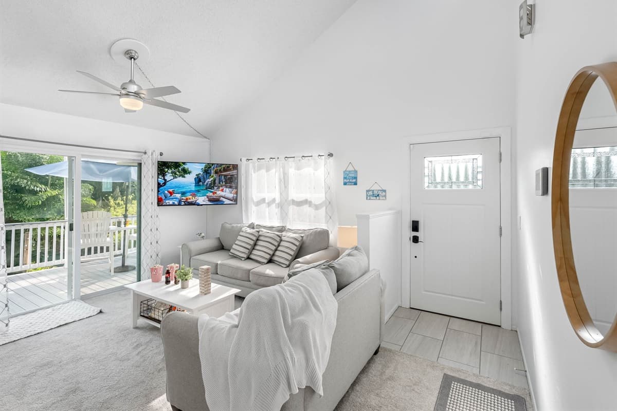 Unwind on the plush sectional sofa, enjoy a favorite show on the flat-screen TV, or simply soak up the calming atmosphere of this cozy space.