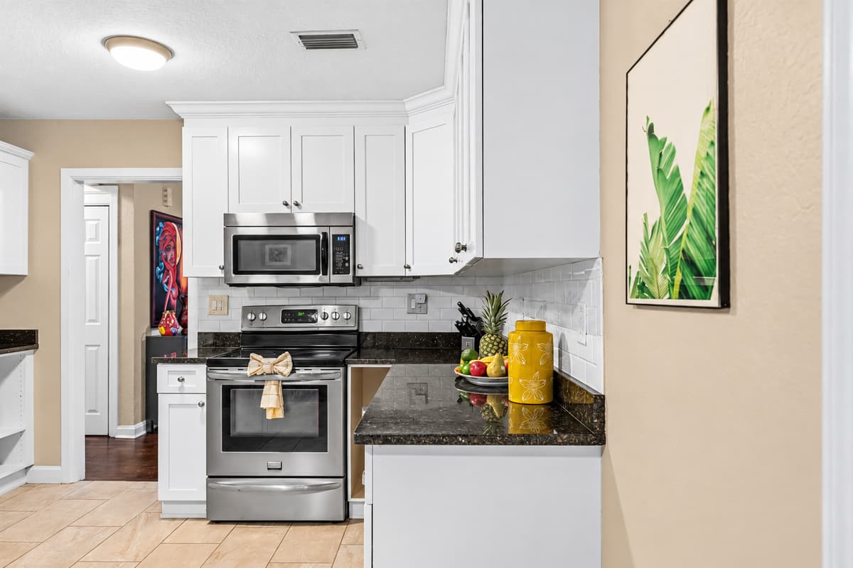 Fully equipped kitchen with oven, microwave, and essentials—ideal for home-cooked meals.