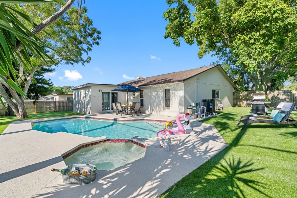 Surrounded by lush greenery, the pool area is designed to provide both relaxation and entertainment, creating an inviting atmosphere for all ages.
