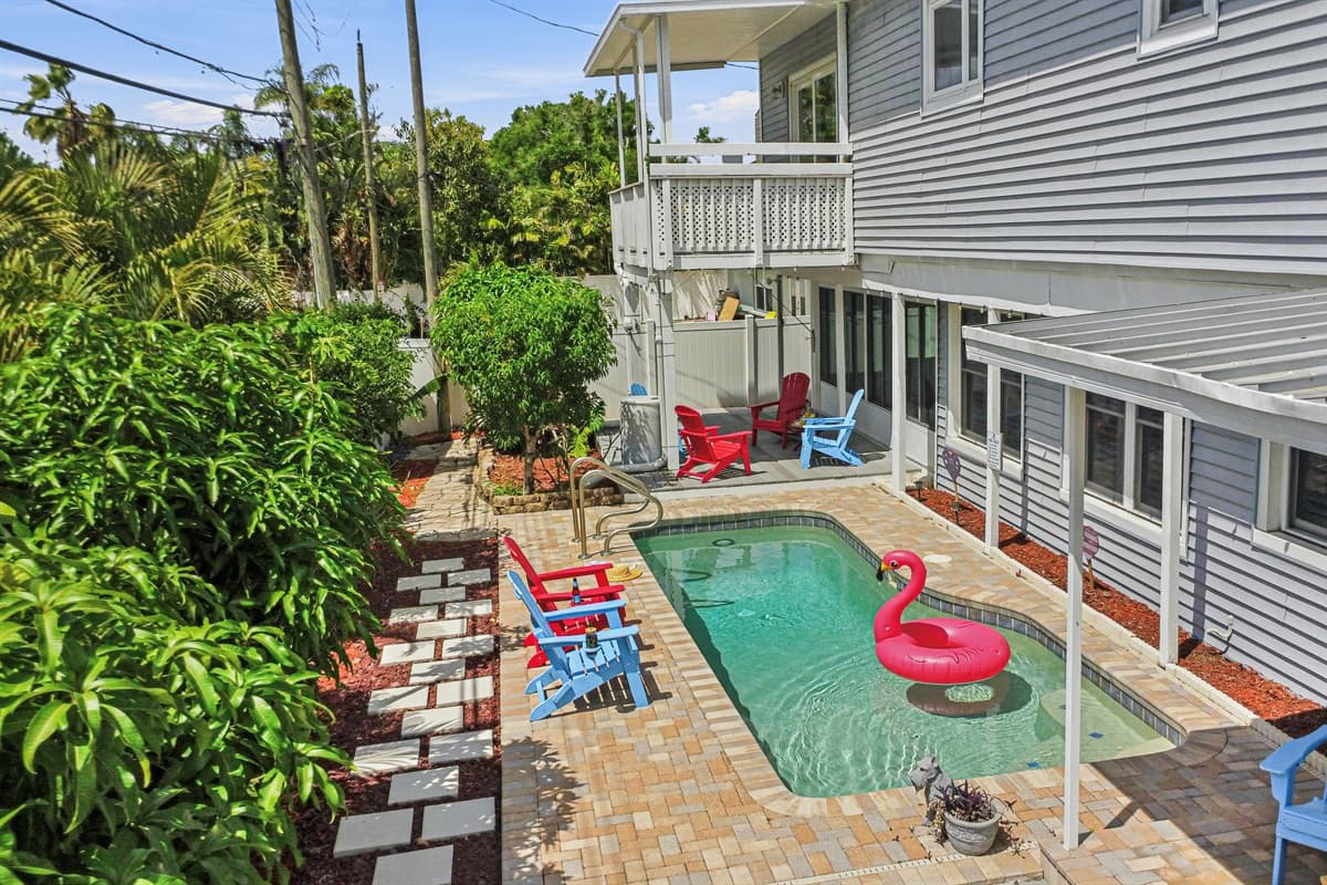 Backyard overview featuring the private pool, lush greenery, and surrounding patio space—your own secluded retreat 