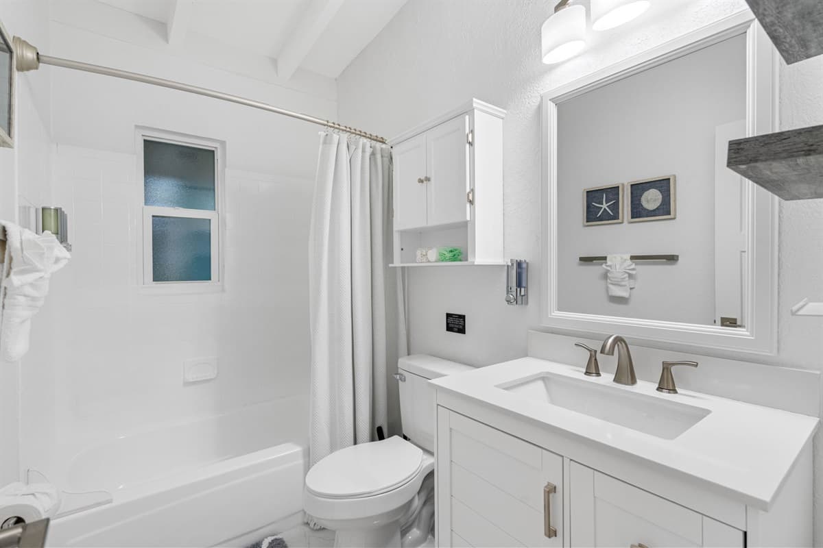Step into this pristine bathroom, a sanctuary of cleanliness and relaxation designed to provide a comfortable and convenient experience.