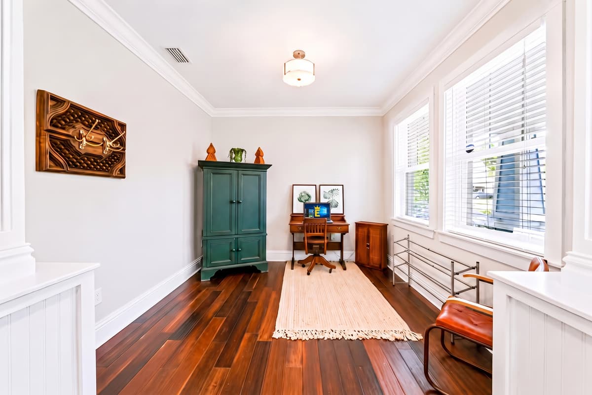 A quiet office area with a desk and comfortable seating, perfect for remote work or catching up on emails.