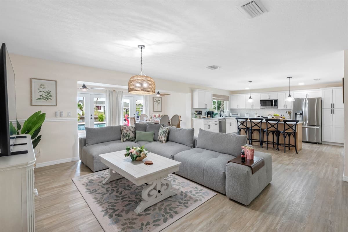 Relax in this inviting living room, featuring a plush sectional sofa perfect for movie nights on the large smart TV.