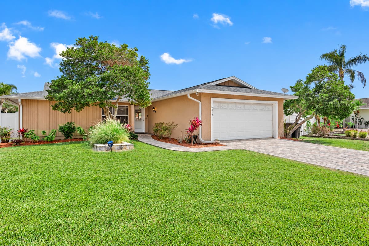 The exterior of the home is adorned with lush landscaping.