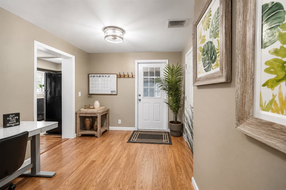 Welcoming entryway with stylish décor and a dedicated workspace nook.