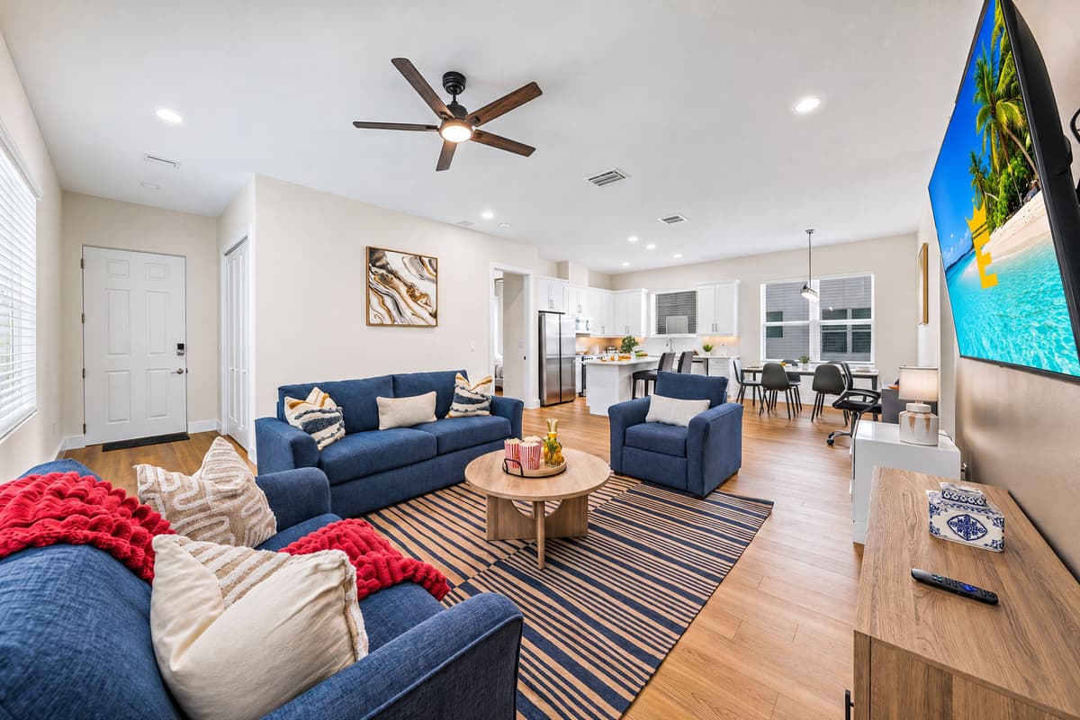The entire open-concept layout in one view — living room, kitchen, and dining all flowing together for the perfect group hangout.