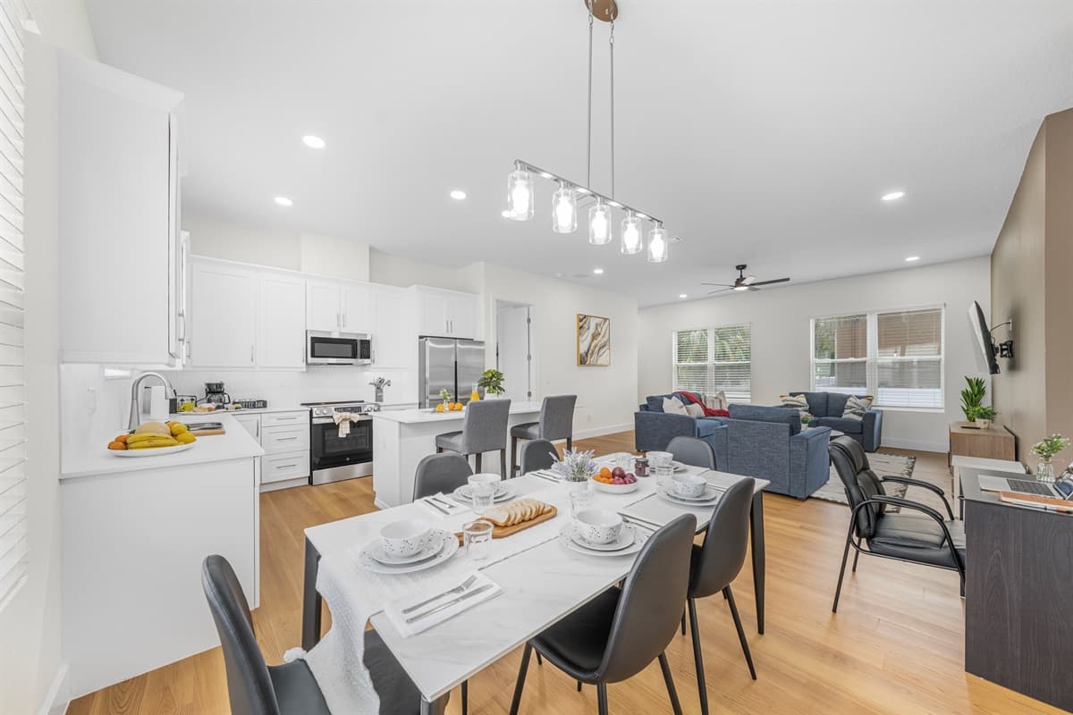 Open-concept dining and living space with a modern kitchen, stylish seating, and plenty of room for gathering and entertaining.