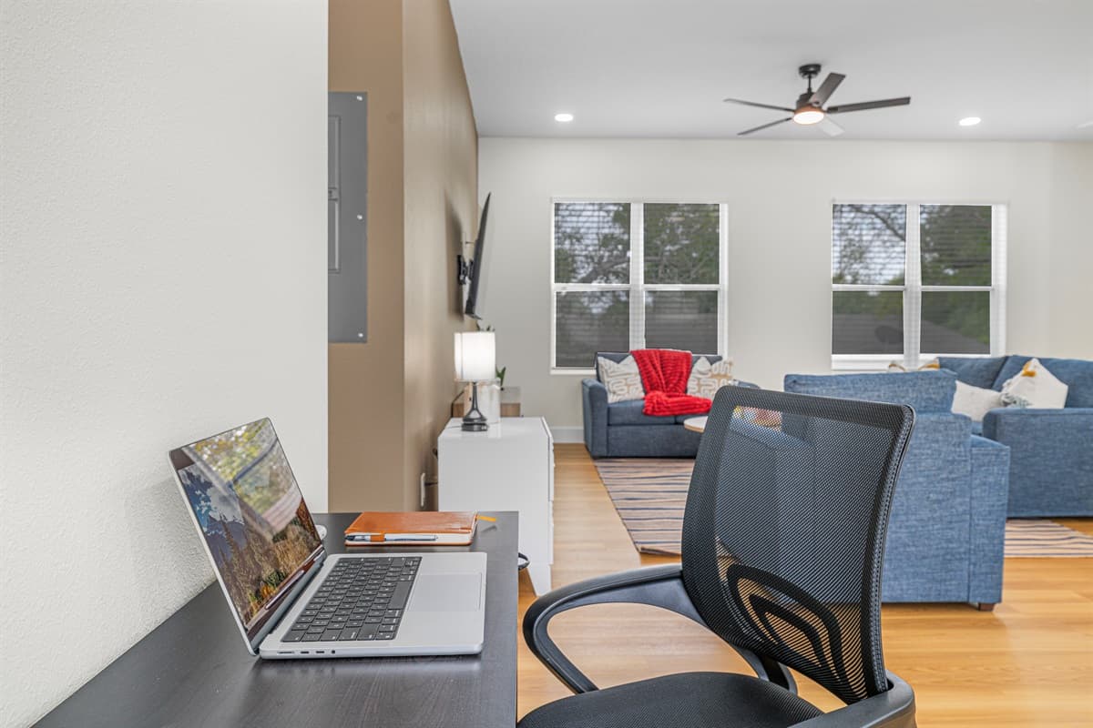 Dedicated workspace with desk and chair, set within an open living area—perfect for remote work with a comfortable, relaxed atmosphere.