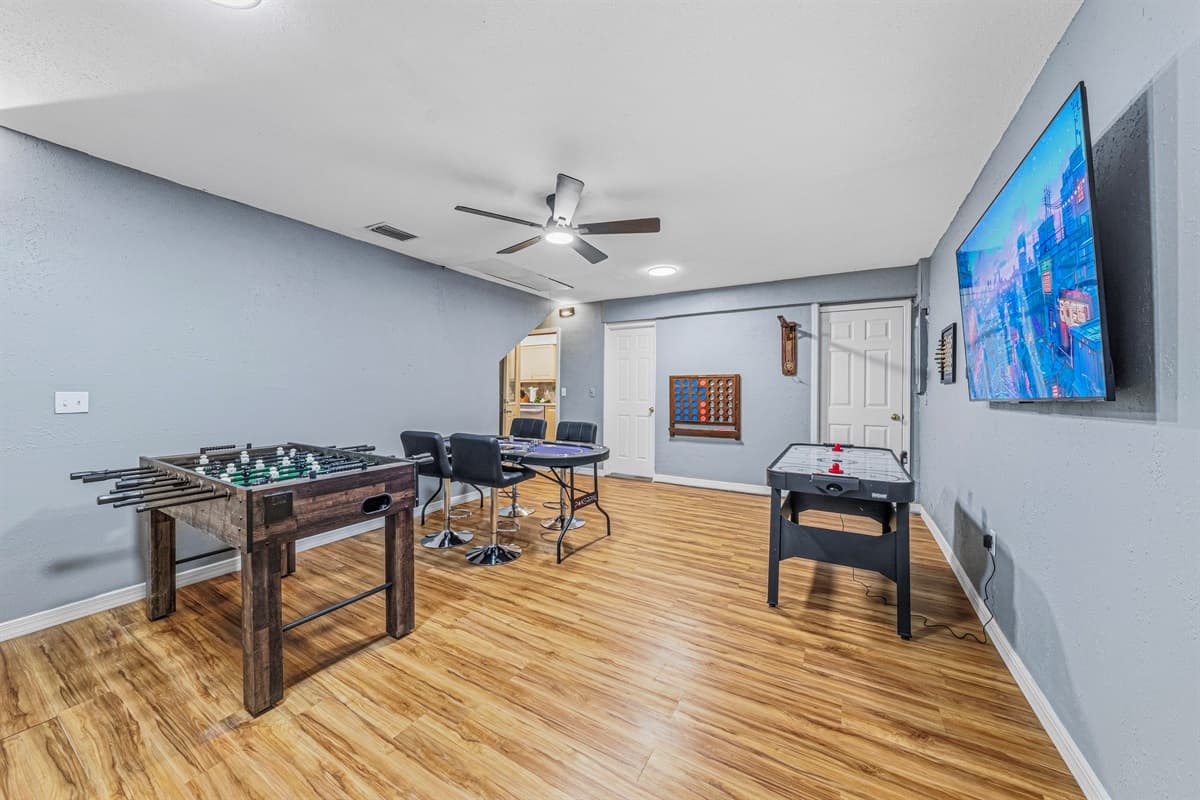 Full game lounge with multiple activities including foosball, arcade-style fun, and big-screen TV 