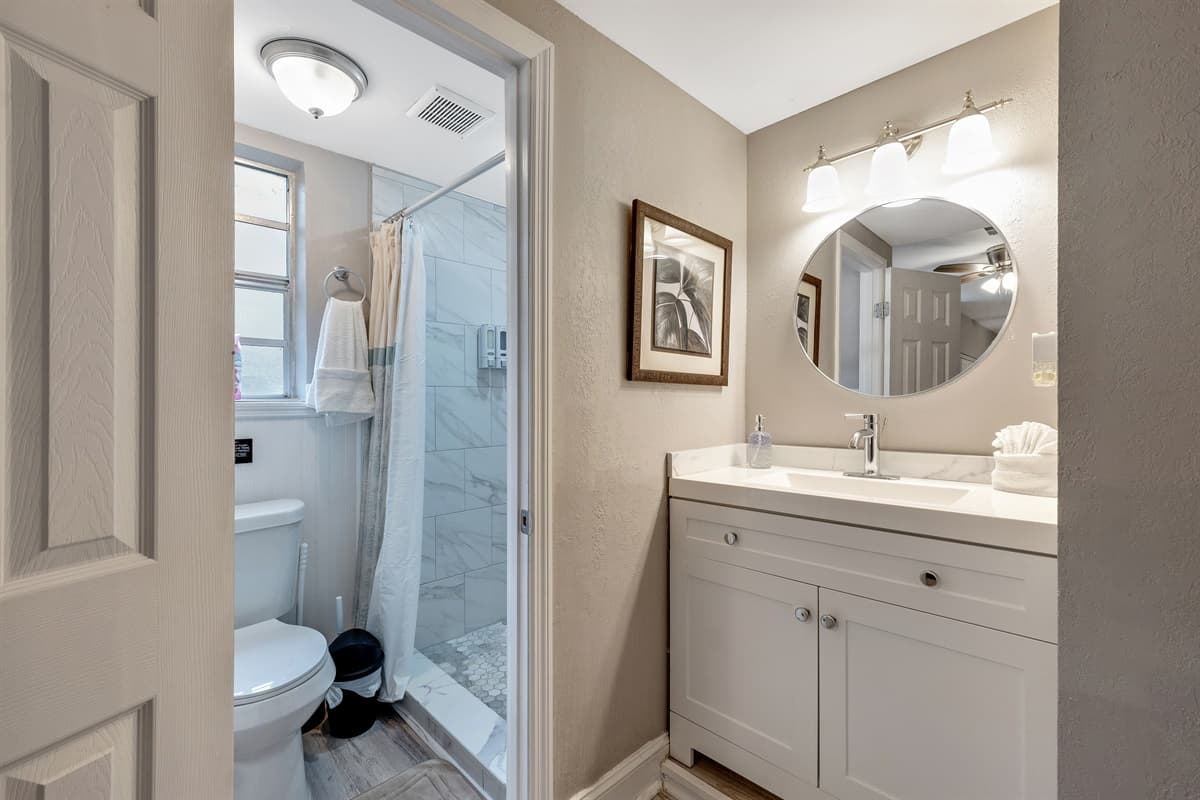 The toilet, discreetly tucked away, ensures your privacy and completes the ensemble of this stylish sanctuary.