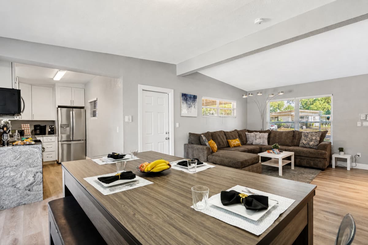 The table's sleek design features a high-quality wood finish that blends seamlessly into any modern interior decor. 