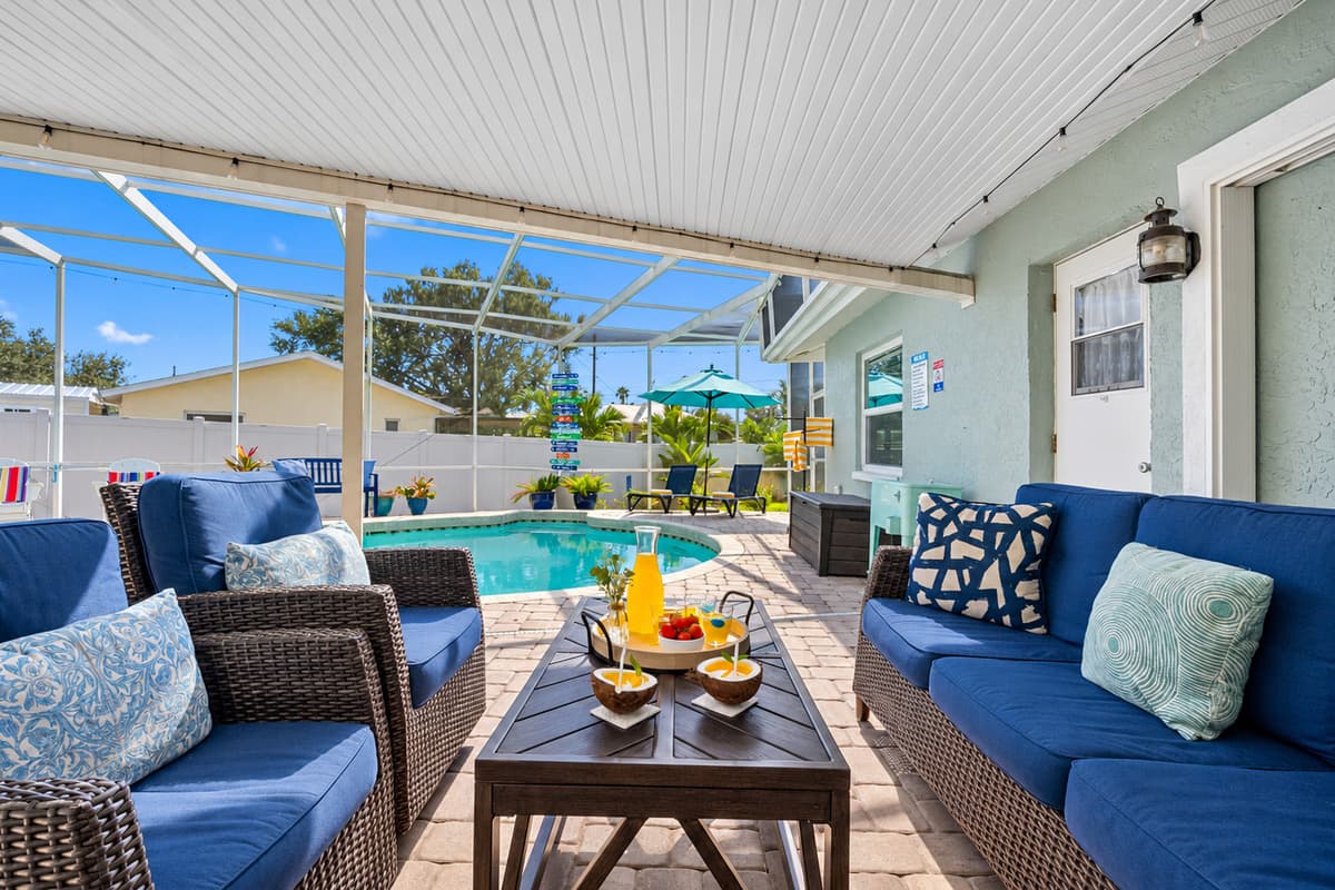 Relax in style under the shaded lanai with plush outdoor seating, perfect for morning coffee, evening cocktails, or simply lounging between swims.