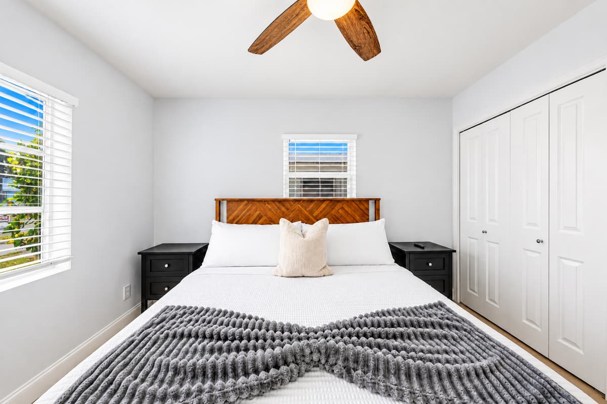 Inviting bedroom with modern décor, soft linens, and ample closet space.