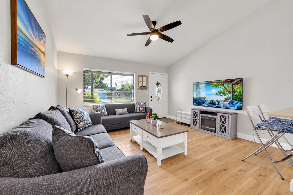 Sectional seating, a Smart TV and the dining table all in one open space — so the movie, the card game and the people still eating dinner all happen at the same time without anyone missing out.