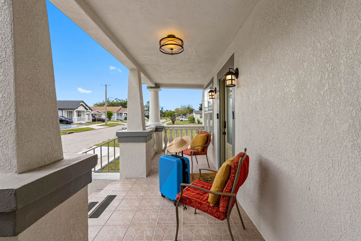 The front porch combines charm and comfort with ample seating and a serene setting, offering guests a relaxing place to start or end their day.