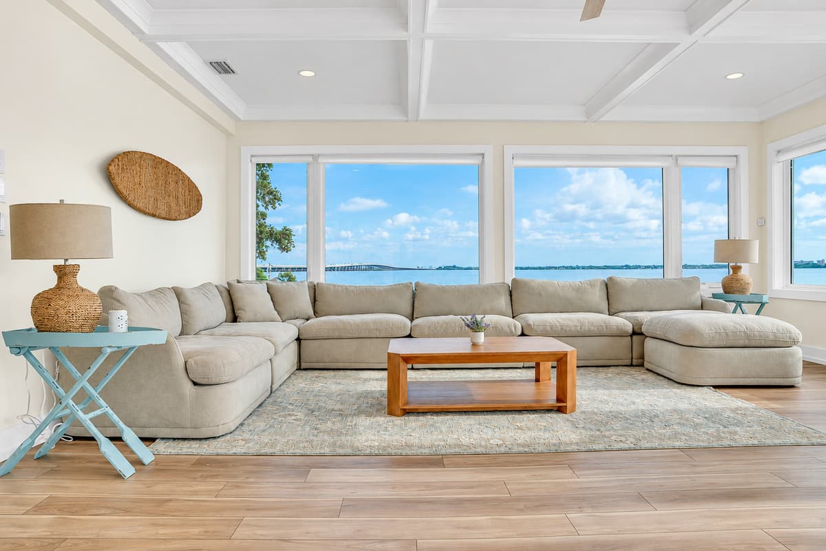 Light, water and room for everyone. The main living area has a massive sectional, coffee table and windows on the bay. Bright, airy and built for groups.