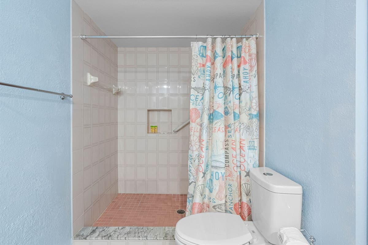 The highlight of the bathroom is the spacious walk-in shower, designed with practicality in mind.