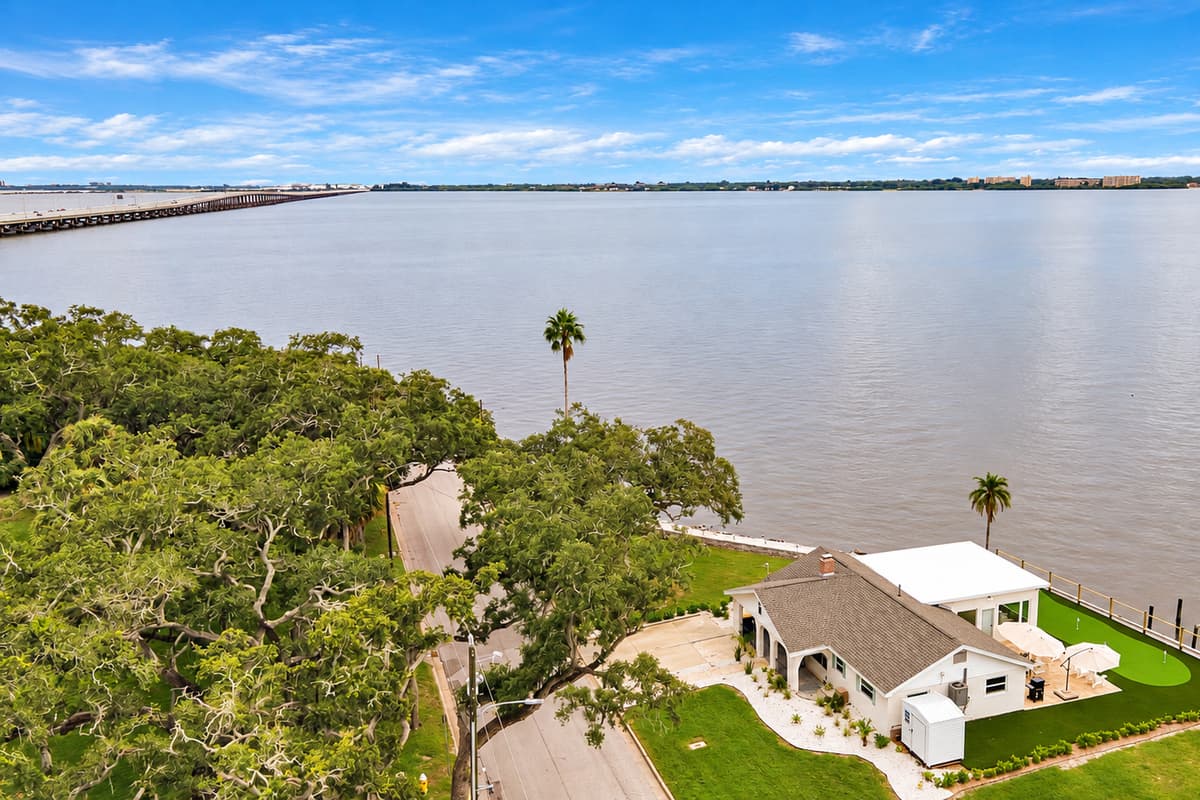 Bay, bridge and blue sky. Mature oaks frame the home, with the bay and bridge stretching out behind it. Nature, water and space, all in one view.