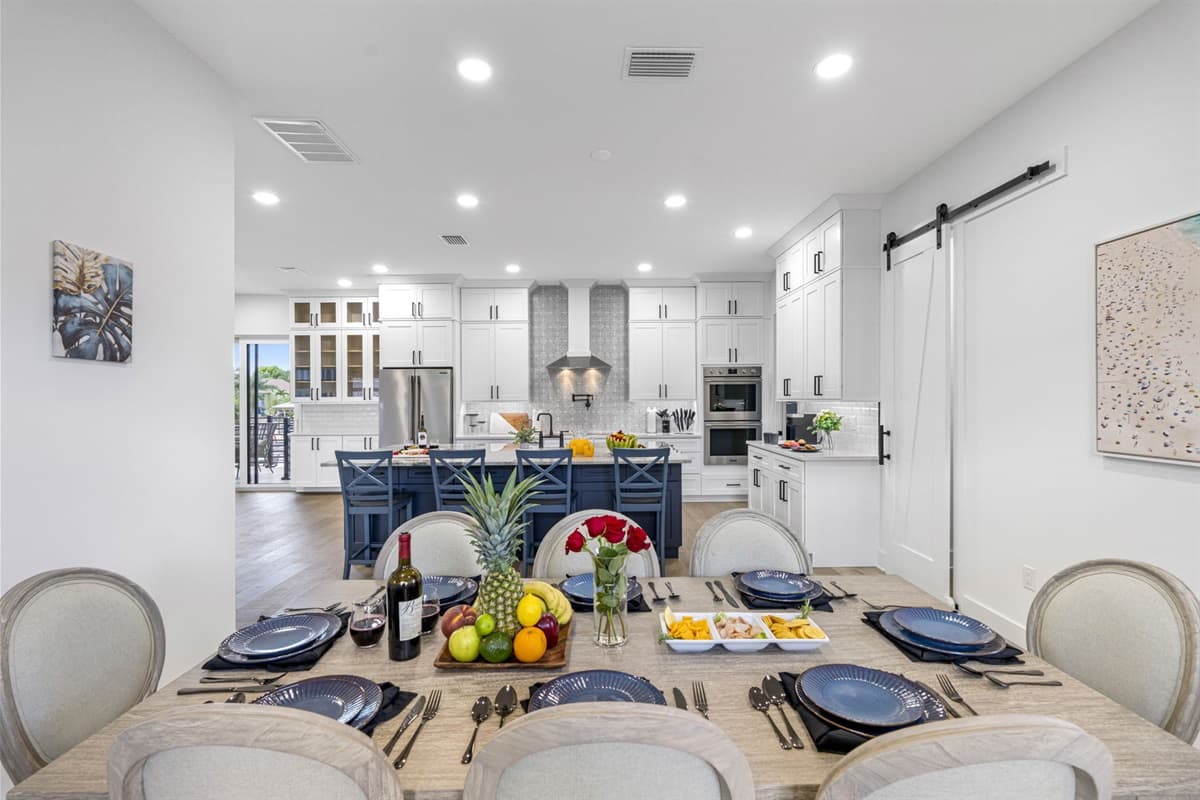 The adjacent dining area offers a large table with plenty of seating, making it the perfect spot for family dinners, celebrations, or casual meals.