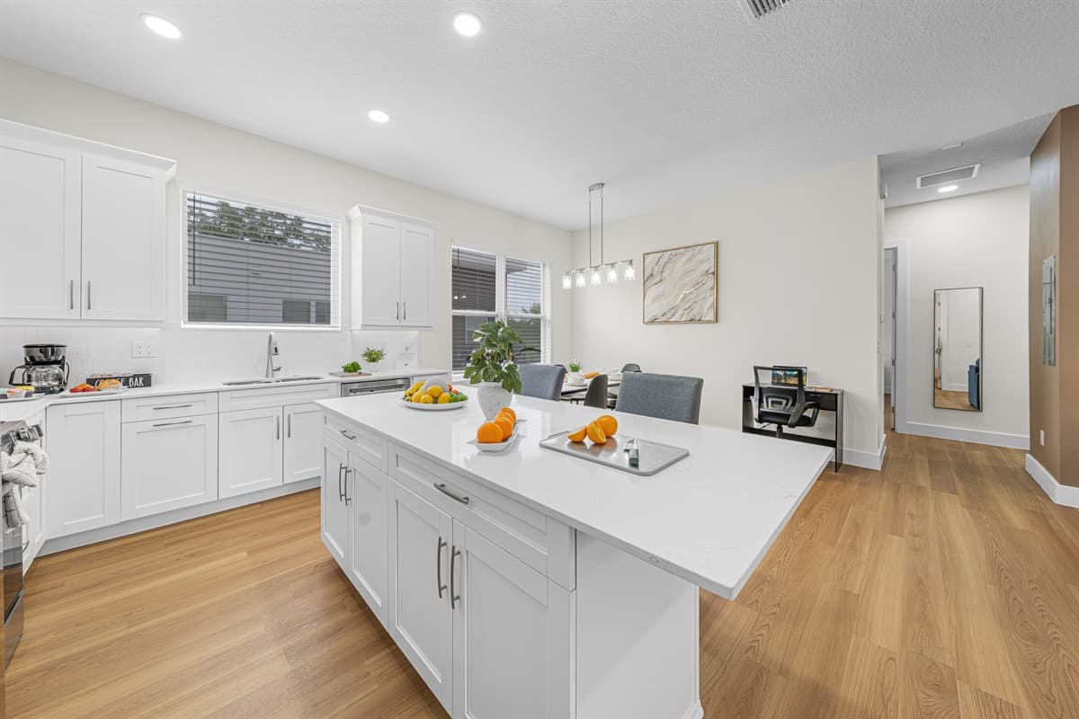 White shaker cabinets, gleaming countertops, and a full-size dishwasher. Cooking in and cleaning up has never been this easy.