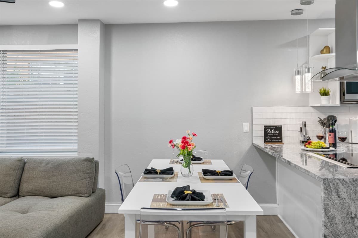 Positioned conveniently across from the kitchen, the dining area allows for easy serving and clean-up, making mealtime a seamless and enjoyable experience.