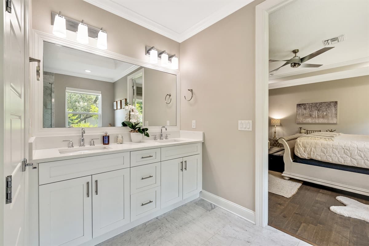 Surrounded by sleek tile and modern fixtures, the tub and shower combination exudes elegance and sophistication.