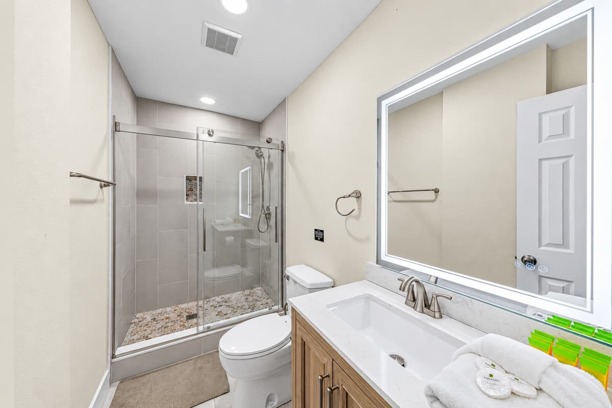 Clean, modern bathroom with a large vanity, bright lighting, and premium finishes.