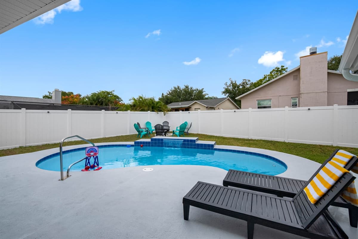 Step into your private backyard oasis, complete with a sparkling pool, shaded patio, and cozy lounge seating — perfect for soaking up Florida’s sunshine.