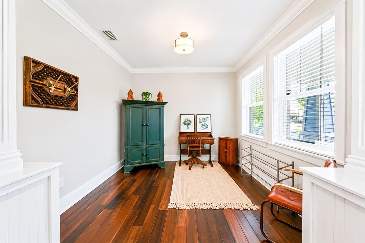 A quiet office area with a desk and comfortable seating, perfect for remote work or catching up on emails.