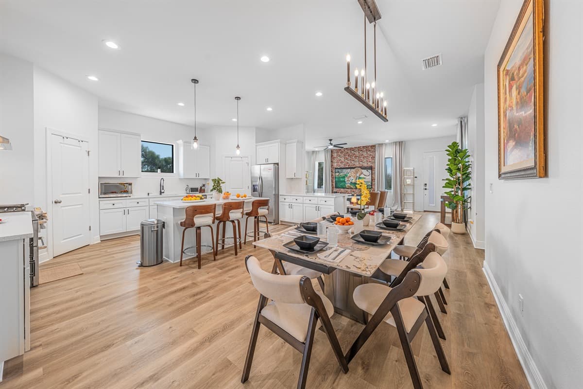 Open-concept kitchen and dining area featuring a large island, modern appliances, and ample seating for group meals.